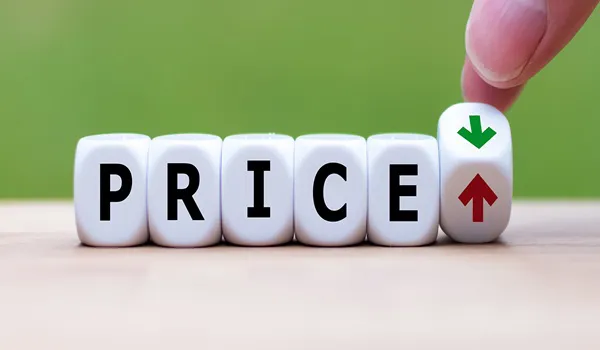 Dice spelling the word price with up and down arrows